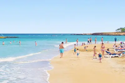 a group of people standing on a beach at Villa Mandy in Protaras