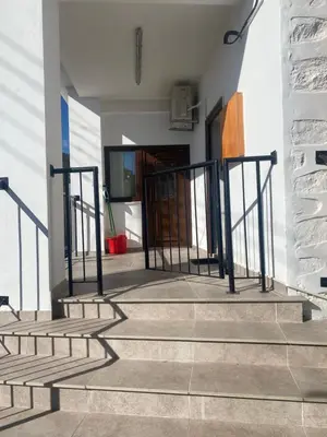 a set of stairs with black railings in a building at TheonikosHouse in Agros