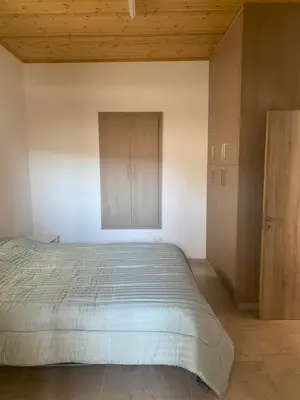 a bedroom with a bed and a wooden ceiling at TheonikosHouse in Agros