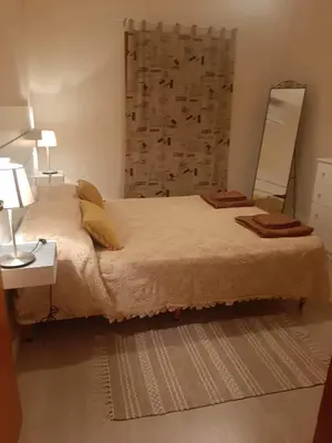 a bedroom with a large bed and a mirror at Klimataria B2 in Pissouri