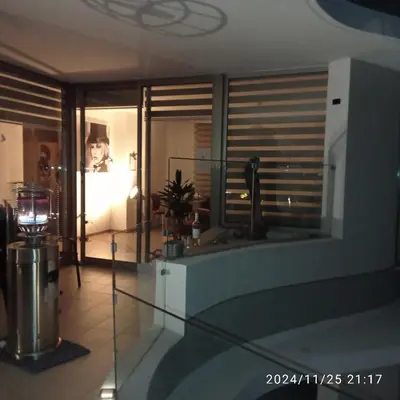 a living room with a glass table and a window at Anamor apartment 408 in Larnaka