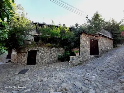 a stone building with two doors on a street at Archontiko Rousias in Nicosia