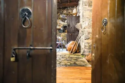an open door to a room with a stone wall at Archontiko Rousias in Nicosia