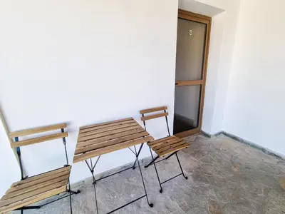 two wooden chairs and a table in a room at Mountains Retreat Rooms & Suites in Ayios Theodhoros