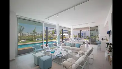 a living room with white furniture and a pool at Protaras Olivine Villa Ol3 in Protaras