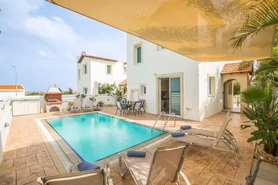 a villa with a swimming pool and a patio at Villa Pepper in Protaras