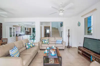 a living room with a couch and a tv at Villa Pepper in Protaras