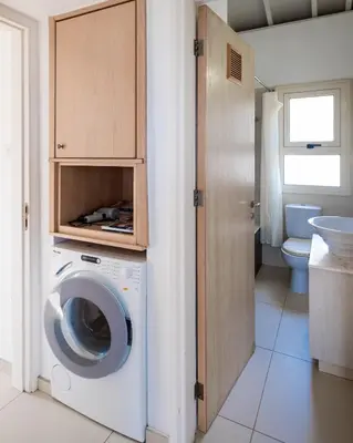 a bathroom with a washing machine and a toilet at Protaras Artisan Seafront Villa 7 in Protaras