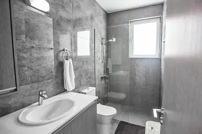 a bathroom with a sink and a toilet and a shower at Villa Macan in Protaras