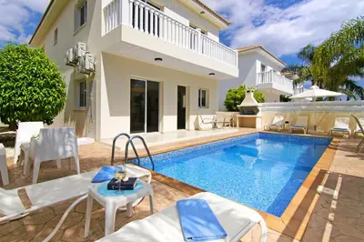 a villa with a swimming pool and a house at Nissi Sapphire Villa in Ayia Napa