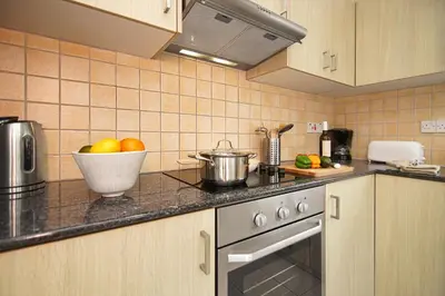 a kitchen with a bowl of fruit on the counter at Nissi Sapphire Villa in Ayia Napa