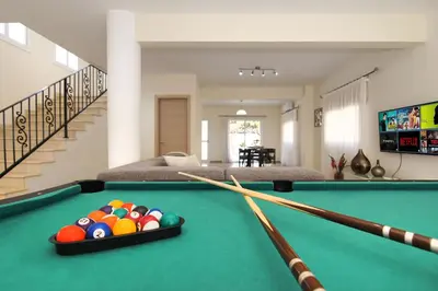 a pool table with balls in a living room at Nissi Adamite Villa in Ayia Napa