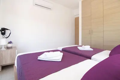 a bedroom with two beds with towels on them at Nissi Adamite Villa in Ayia Napa