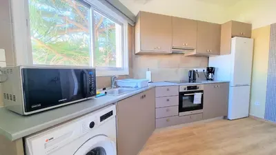 a kitchen with a dishwasher and a tv on a counter at The Urban Oasis - Comfort 2br near the City Center, 200Mbit Internet and Smart TV in Larnaka