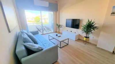 a living room with a couch and a tv at The Urban Oasis - Comfort 2br near the City Center, 200Mbit Internet and Smart TV in Larnaka