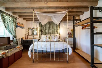 a bedroom with a bed with a canopy at Rozana House in Silikou
