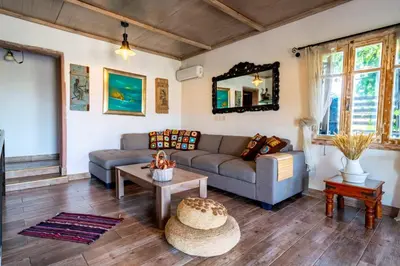 a living room with a couch and a table at Rozana House in Silikou