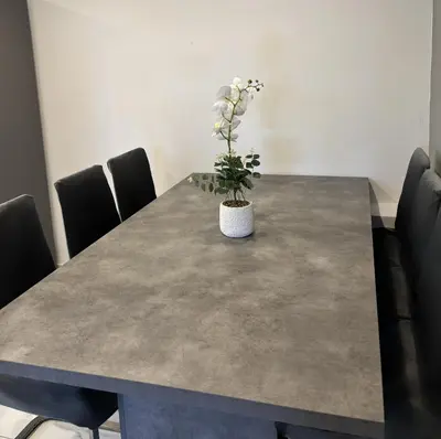 a dining room table with a potted plant on it at Sant Central Deluxe Apartments in Ayia Napa