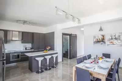 a kitchen and dining room with a table and chairs at Villa Demeter GA98 in Paralimni