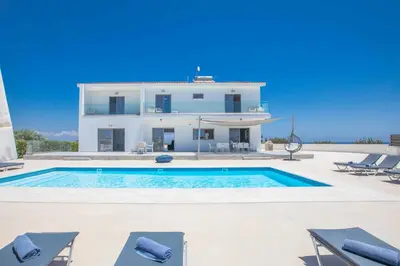 a villa with a swimming pool in front of a house at Villa Demeter GA98 in Paralimni