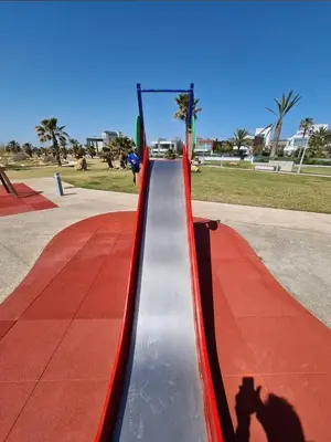 a shadow of a person taking a picture of a slide at Seaview Luxury Villa Fortuna in Ayia Napa