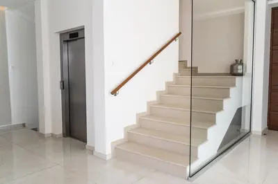 a staircase in a house with a glass railing at Seaview Luxury Villa Fortuna in Ayia Napa