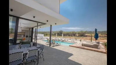 a house with a patio with a swimming pool at Protaras Elite Pearl Villa Ep17 in Protaras