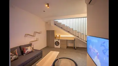 a living room with a couch and a table and stairs at Protaras Elite Pearl Villa Ep17 in Protaras