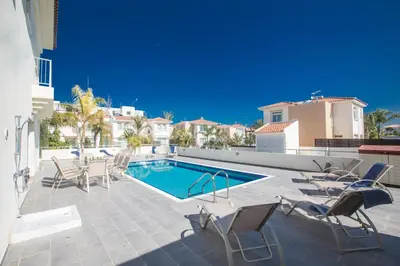 a patio with chairs and a swimming pool at Protaras Holiday Villa Dv1 in Protaras