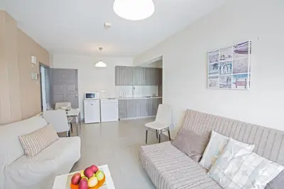 a living room with a couch and a table at Ayia Napa Holiday Apartment So7 in Ayia Napa