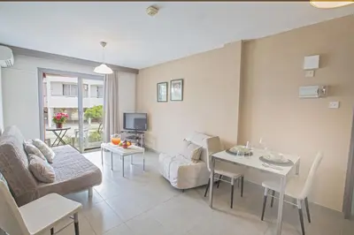a living room with a couch and a table at Ayia Napa Holiday Apartment So7 in Ayia Napa