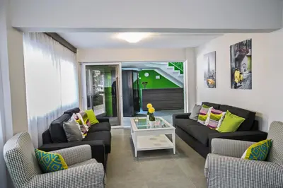 a living room with two couches and a table at Ayia Napa Holiday Apartment So4 in Ayia Napa