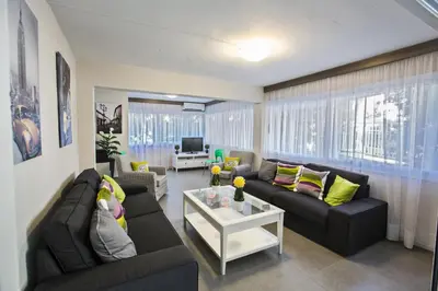 a living room with two couches and a table at Ayia Napa Holiday Apartment So3 in Ayia Napa