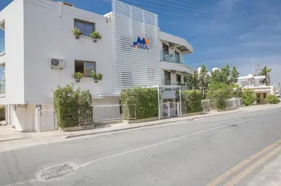 a white building on the side of a street at Ayia Napa Holiday Apartment So3 in Ayia Napa