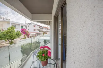 a balcony with a potted plant on a table at Ayia Napa Holiday Apartment So6 in Ayia Napa
