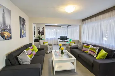 a living room with couches and a table at Ayia Napa Holiday Apartment So6 in Ayia Napa