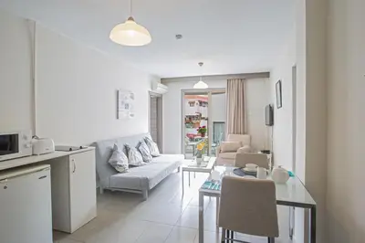a living room with a couch and a table at Ayia Napa Holiday Apartment So8 in Ayia Napa