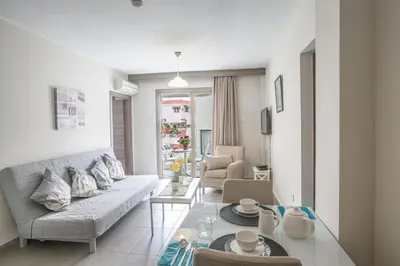 a living room with a couch and a table at Ayia Napa Holiday Apartment So8 in Ayia Napa