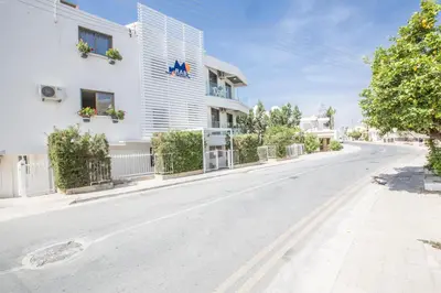 an empty street in front of a white building at Ayia Napa Holiday Apartment So9 in Ayia Napa