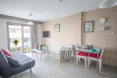 a living room with a couch and a table at Ayia Napa Holiday Apartment So9 in Ayia Napa