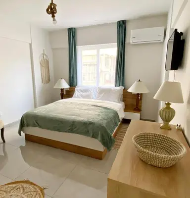a bedroom with a large bed and a window at Peaceful 2 bedroom Flat in Engomi
