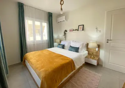 a bedroom with a large bed and a window at Peaceful 2 bedroom Flat in Engomi