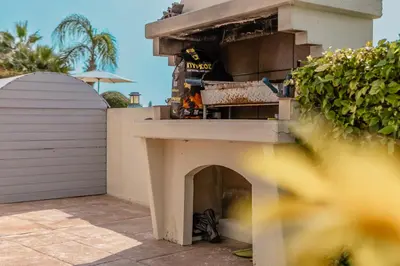 a building with a pizza oven in a yard at Villa Mespila_ Ayia Napa in Ayia Napa