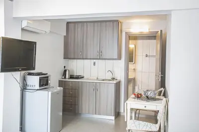 a kitchen with a white refrigerator and a microwave at Ayia Napa Holiday Apartment Ss1 in Ayia Napa