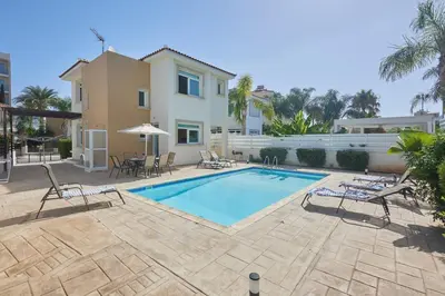 a swimming pool in front of a house at Protaras Holiday Villa Dv27 in Protaras