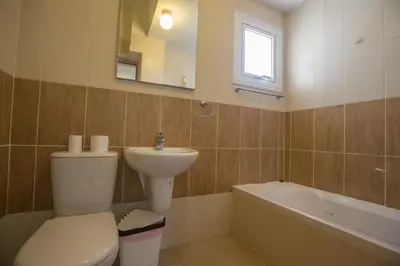 a bathroom with a toilet and a sink and a bath tub at Protaras Delfini Villa Dv4 in Protaras
