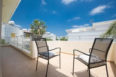 two chairs sitting on the balcony of a house at Protaras Delfini Villa Dv4 in Protaras