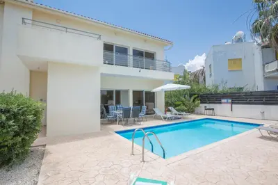 a swimming pool in the backyard of a house at Protaras Delfini Villa Dv4 in Protaras