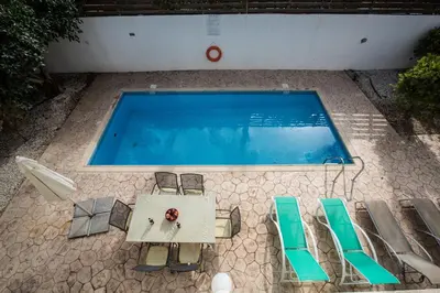 an overhead view of a swimming pool with a table and chairs at Protaras Delfini Villa Dv5 in Protaras