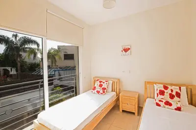 a bedroom with a bed and a large window at Protaras Delfini Villa Dv5 in Protaras